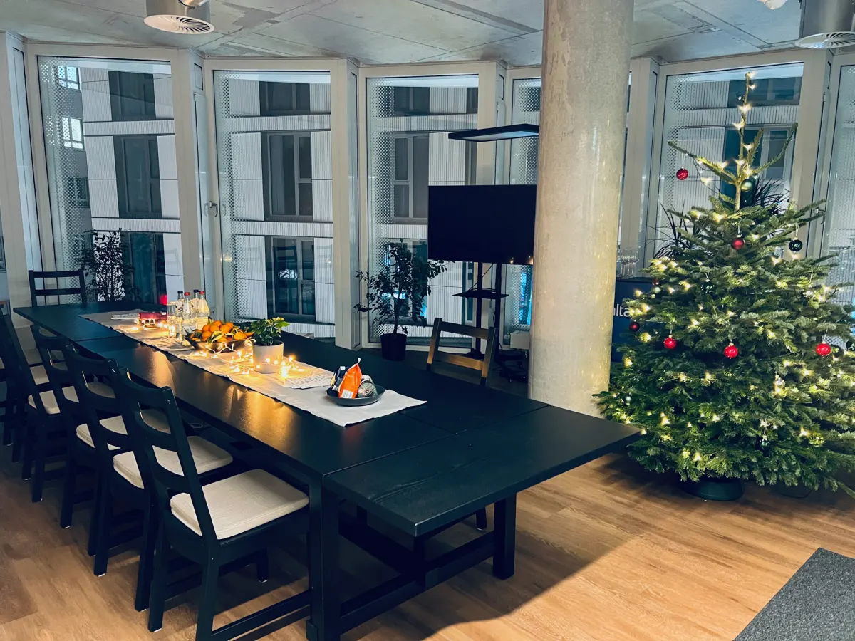 Common area at the AltaSigma office with a long table and a decorated Christmas tree